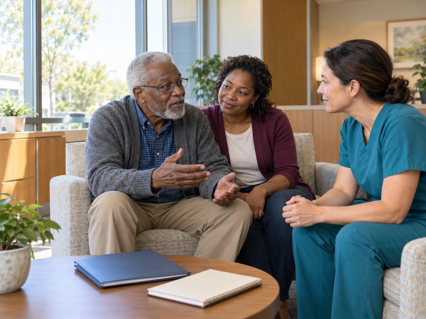 BestCareMatch | Care transition planning An older man and an adult family member talk with a care professional in teal scrubs in a consultation lounge. BestCareMatch illustrative photo.